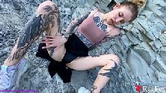 Tattooed girl fingering pussy by the sea
